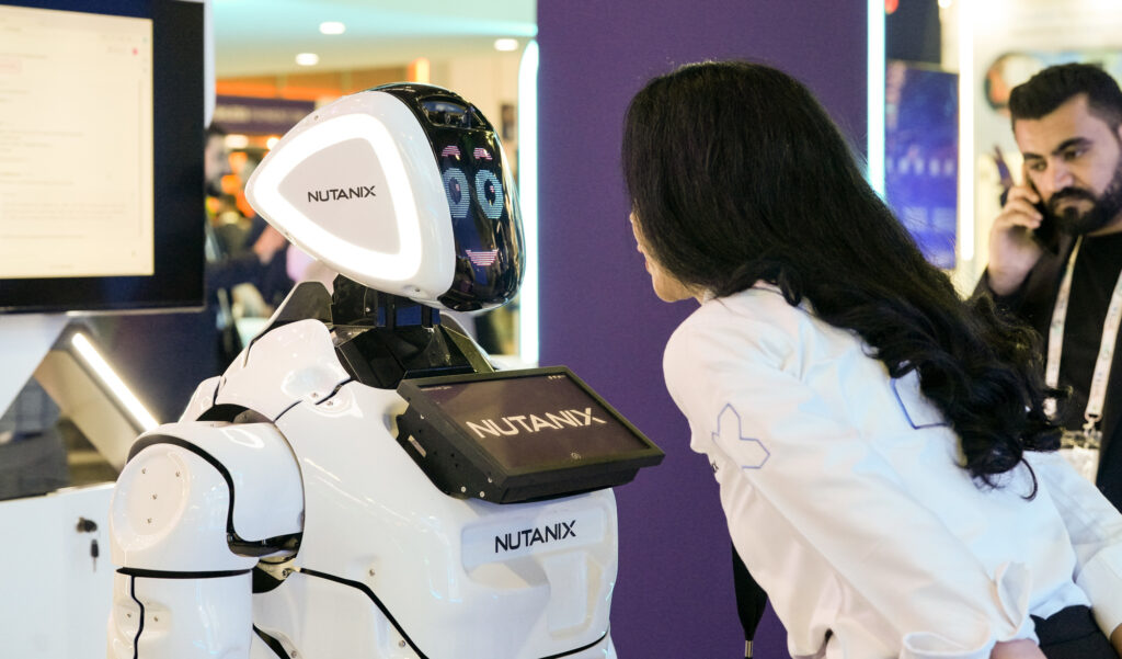 GITEX Global – Robotics Innovation Visitor interacting with a Nutanix robot at GITEX Global