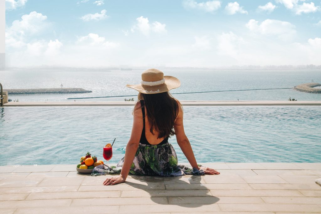 Vida Beach Resort Marassi Al Bahrain Pool Woman relaxing by the infinity pool at Vida Beach Resort Marassi Al Bahrain